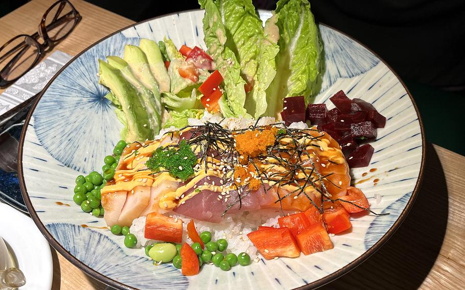The Mizuki poke bowl includes tuna, salmon and butterfish with avocado, lettuce, peas, bell peppers, other vegetables and rice. It's one of the non-Japanese items on the menu of Mizuki in Kaiserslautern, Germany.