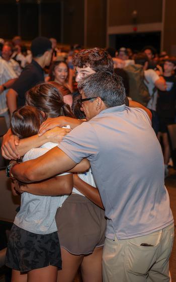 A family embraces.