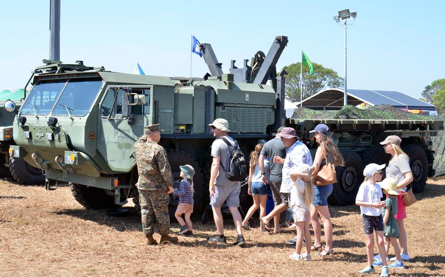 Lance Cpl. Jordan Hernandez, 22, of Oceanside, Calif., helps visitors check out a Marine Corps tactical vehicle during an open house at Royal Australian Air Force Base Darwin, Australia, Saturday, Aug. 27, 2022. 