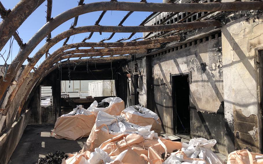 A tool shed atop the roof of a building in Chatan, Okinawa, was damaged by a fire, Sunday, Jan. 15, 2023.