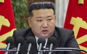 Kim Jong Un speaking into five microphones.