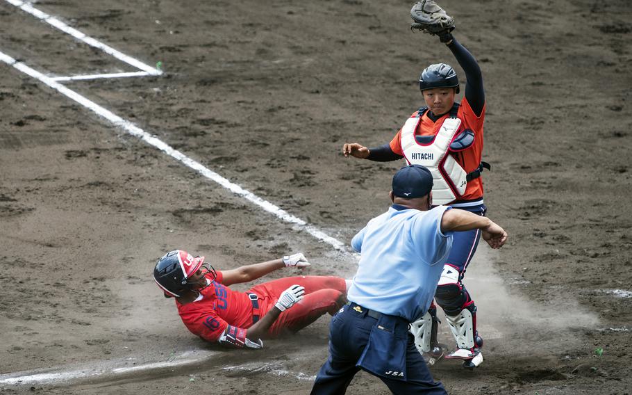 Michelle Moultrie, an outfielder for the U.S. Women’s Olympic softball team, slides into home plate during an exhibition game against the Hitachi Sundivas in Iwakuni, Japan, Monday, July 12, 2021. 