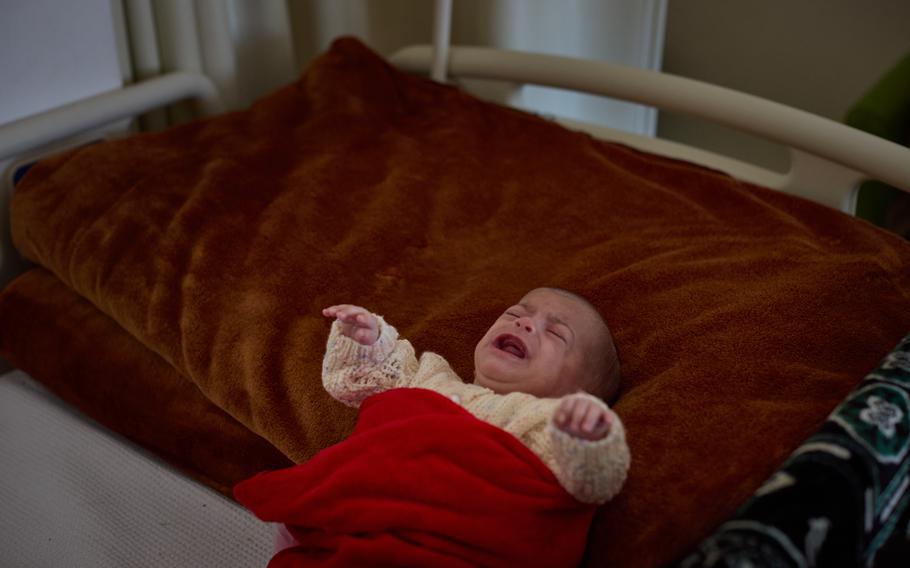 Massa, on a hospital bed next to her mother.