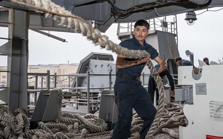A sailor heaves a rope