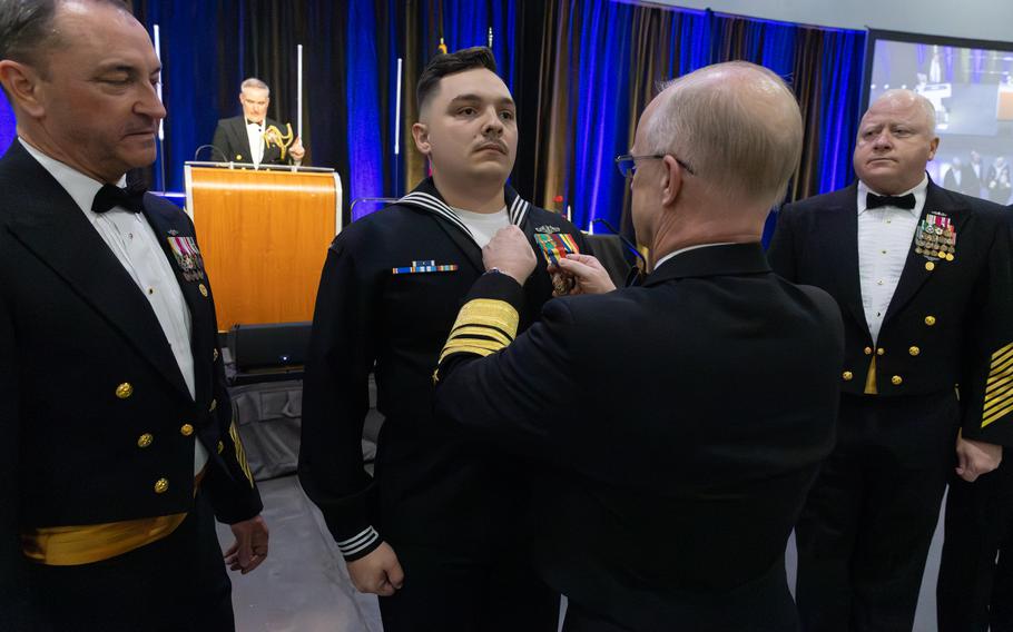 Adm. Daryl Caudle presents 1st Class Gabriel Journey with the Navy and Marine Corps Medal