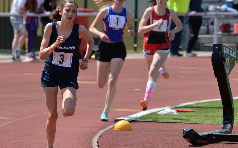 Lakenheath’s Abra Mills leads Ramstein’s Julia Harris and Kaiserslautern’s Piper Parsells, on her way to winning the girls 1,600-meter race at the DODEA-Europe track and field championships in Kaiserslautern, Germany, May 19, 2023. She won in 5 minutes, 18.45 seconds, a personal best.