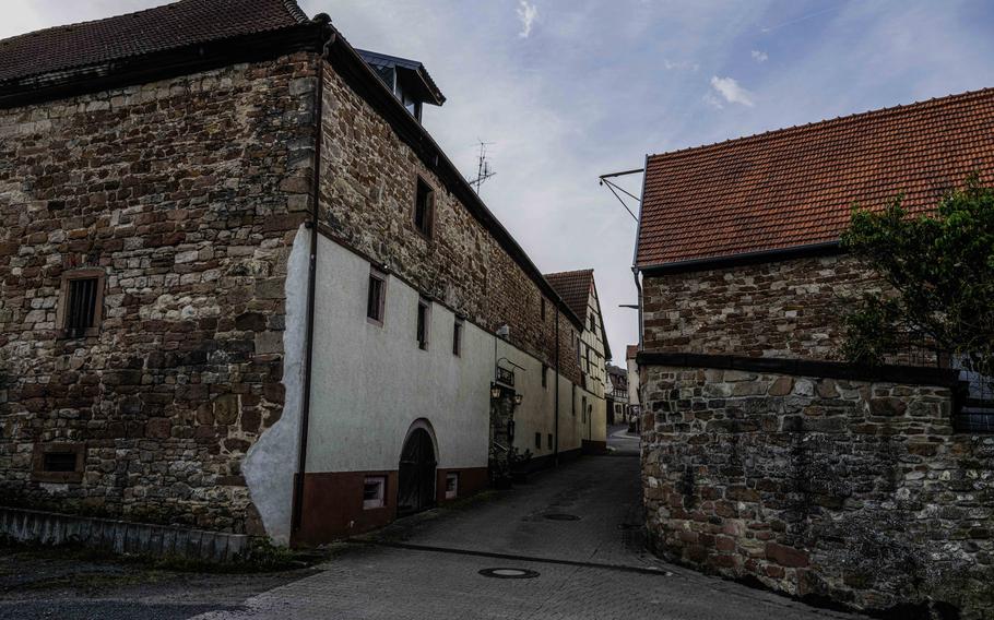 The quaint alley leading to Grifo Restaurant in Kerzenheim, Germany. Nestled between rustic farm buildings in the small village, the entrance of the restaurant seems almost hidden.