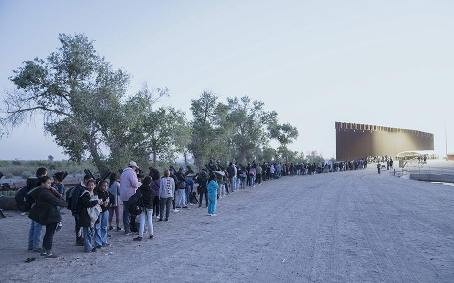 Migrants surrender to U.S. Border Patrol agents at the US-Mexico border in Yuma, Arizona, on May 11, 2023.