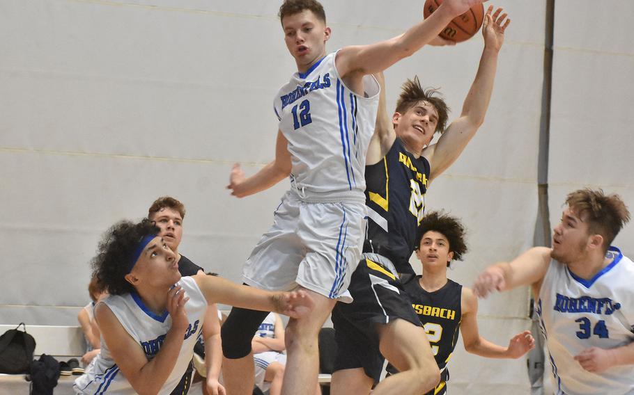 Ansbach's Lucas Morecraft went in for a layup and chaos ensued as AFNORTH defenders converged in a pileup in action on Friday, Feb. 25, 2022 at the DODEA-Europe Division III basketball championships.