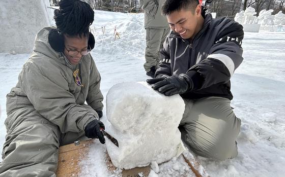 Petty Officer 2nd Class Jade Paisley, left, and Navy Petty Officer 2nd Class Johnpaulo Clavio work on the Navy's sculture for the Sapporo Snow Festival in Hokkaido, Japan, Jan. 29, 2024. 
