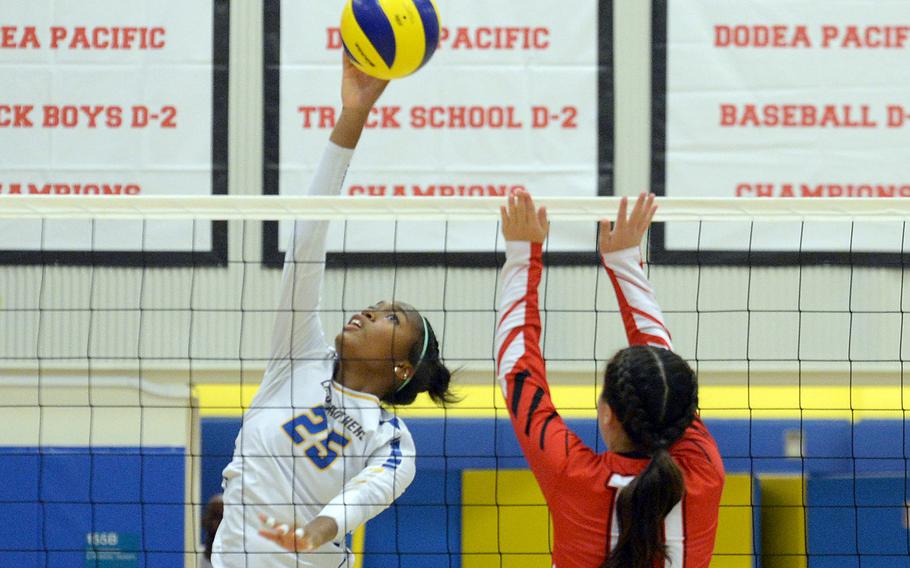 Yokota's Trinity Stegall spikes against E.J. King's Maliwan Schinker during Friday's DODEA-Japan volleyball match. The Cobras won in three sets.