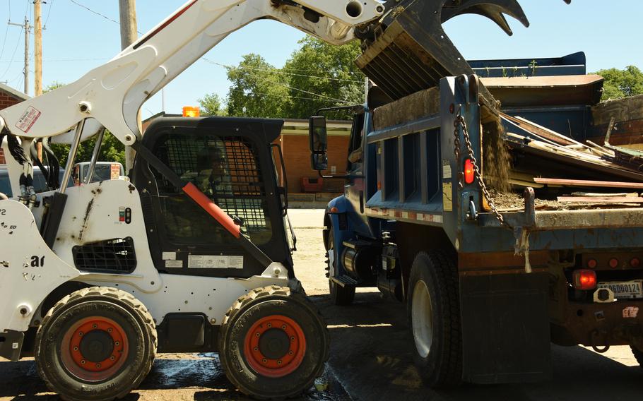 U.S. Air National Guard Staff. Sgt. Derrick Colye dumps debris in a dump truck in Sioux Rapids, Iowa, June 30, 2024. 