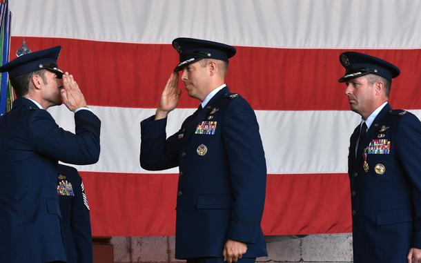 Maj. Gen. Paul Moga, 3rd Air Force commander,  and Cols. Kevin Crofton and William Lutmer, from left, stand at attention during the 52nd Fighter Wing change-of-command ceremony at Spangdahlem Air Base, Germany, on June 30, 2025. Lutmer took over command of the wing from Crofton, who led Spangdahlem for the past two years.
