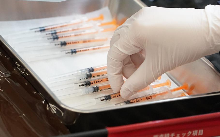 A health-care worker prepares the Moderna coronavirus vaccine booster shots for Rakuten Group employees and their family members at the company’s head office in Tokyo, Japan, on Friday, Feb. 18, 2022.