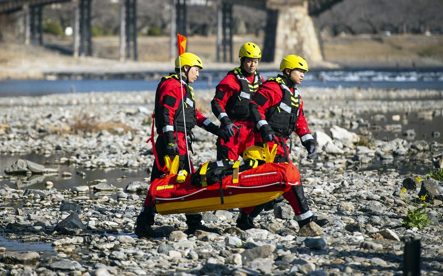 Firefighters demonstrate EMILY — the Emergency Integrated Lifesaving Lanyard — on the Nishiki River in Iwakuni, Japan, on Feb. 13, 2024.