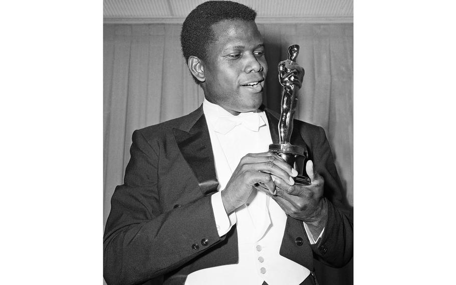 Actor Sidney Poitier poses with his Oscar for best actor for “Lillies of the Field” at the 36th Annual Academy Awards in Santa Monica, Calif. on April 13, 1964. Poitier died Thursday, Jan. 6, 2022 in the Bahamas. He was 94.