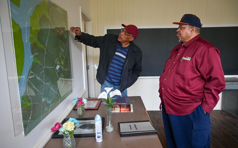 Newell Quinton, left, and Rudolph Eugene Stanley look at a map of San Domingo in the former Rosenwald School building. The cousins collaborated on a project to pinpoint the sites of more than 200 past and present homes.