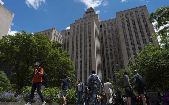 FILE - People walk by the Manhattan Criminal Court building, Wednesday, May 29, 2024, in New York. (AP Photo/Julia Nikhinson, File)