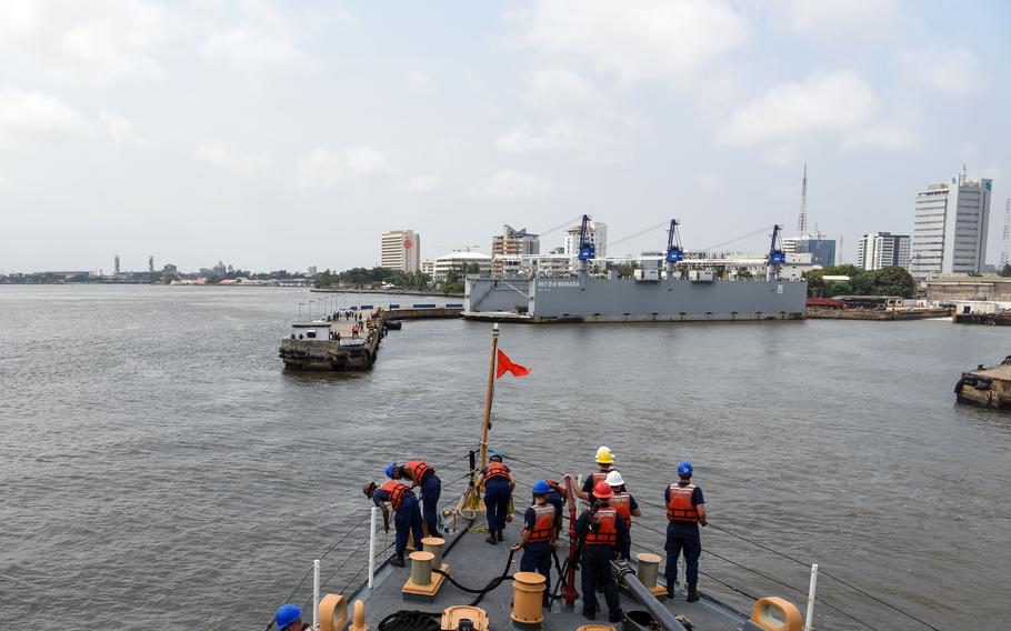 Crew members assigned to USCGC Mohawk prepare to moor to a pier in Lagos, Nigeria, Aug. 18, 2022. 
