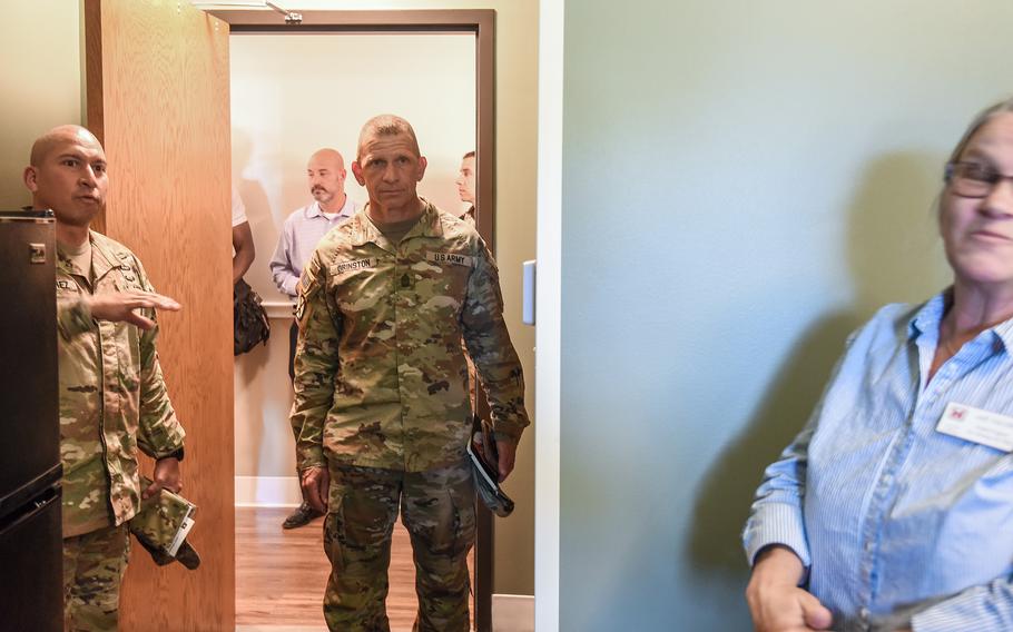 Sgt. Maj. of the Army Michael Grinston, center, tours newly renovated barracks rooms at Fort Benning’s Olson Hall, known as the Cuartels barracks, during a visit to the installation Tuesday, Sept. 13, 2022. Fort Benning began renovating the 1920s-era barracks in 2020, and they project is expected to span about 10 years.