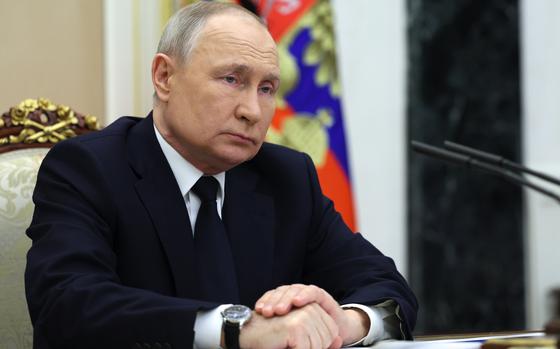 Russian President Vladimir Putin listens to Russian Transport Minister Vitaly Savelyev during their meeting in Moscow, Russia, Saturday, March 25, 2023. (Gavriil Grigorov, Sputnik, Kremlin Pool Photo via AP)