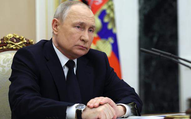 Russian President Vladimir Putin listens to Russian Transport Minister Vitaly Savelyev during their meeting in Moscow, Russia, Saturday, March 25, 2023. (Gavriil Grigorov, Sputnik, Kremlin Pool Photo via AP)