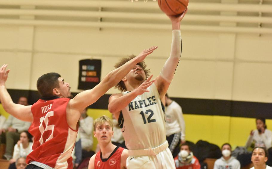 American Overseas School of Rome's Matija Marojevic tries to stop Naples' Keith Rascoe from scoring Friday, March 4, 2022, at the DODEA-Europe Division II basketball championships.