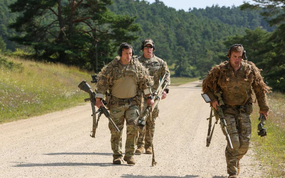 U.S. soldiers run to the next checkpoint during the 2021 Best Sniper Team Competition at Hohenfels Training Area, Germany, Aug. 12, 2021. 