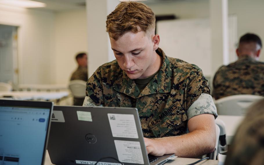 A Marine types on a computer.
