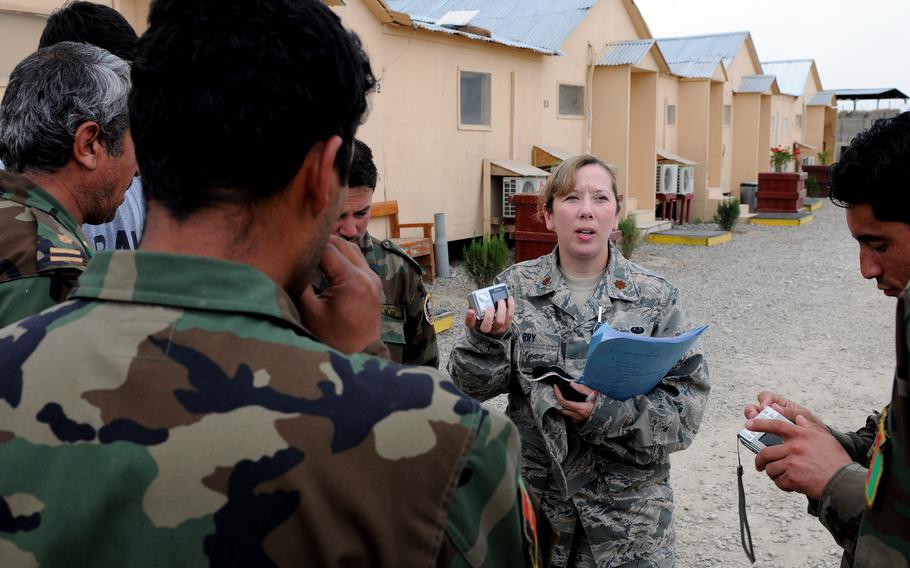 U.S. Air Force Maj. Christy Barry speaks Dari with Afghan national army officers in 2009 at the Counter Insurgency Training Academy on Camp Julien, Afghanistan, while with the Afghanistan-Pakistan Hands program. Barry said she feels anxiety as she reads the news about Afghanistan and worries about her Afghan friends and coworkers. 