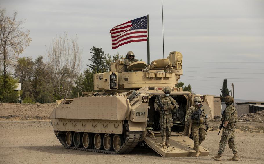 U.S. soldiers with the 1st Armored Division dismount from their M2 Bradley in Syria, Oct. 25, 2020. 