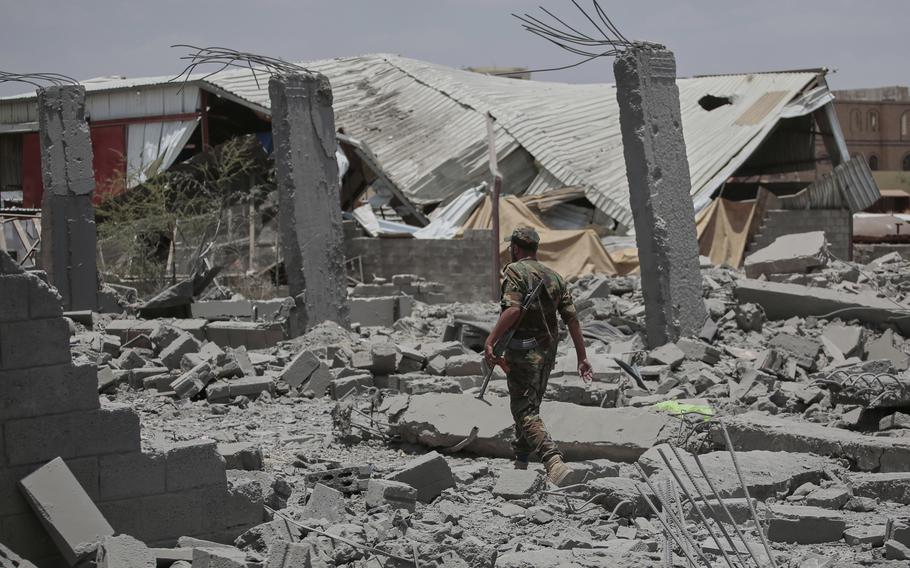 A soldier walking through rubble.