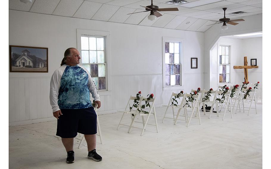 David Colbath visits the church where he was shot nine times, which is now a memorial. Chairs with roses honor the people killed in the massacre.