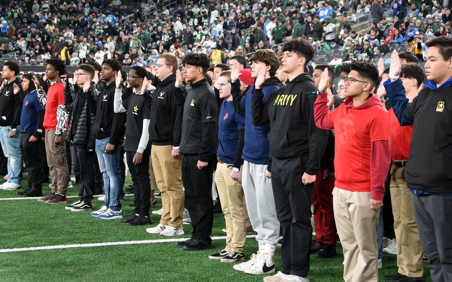 New military recruits are sworn into their respective branches during a ceremony at the New York Jets "Salute to Service" pre-game activities at MetLife Stadium in East Rutherford, N.J. on Nov. 6, 2023. A a new Rand Corp. report released Dec. 14 found that a majority of Americans would discourage young people they know from joining the military.