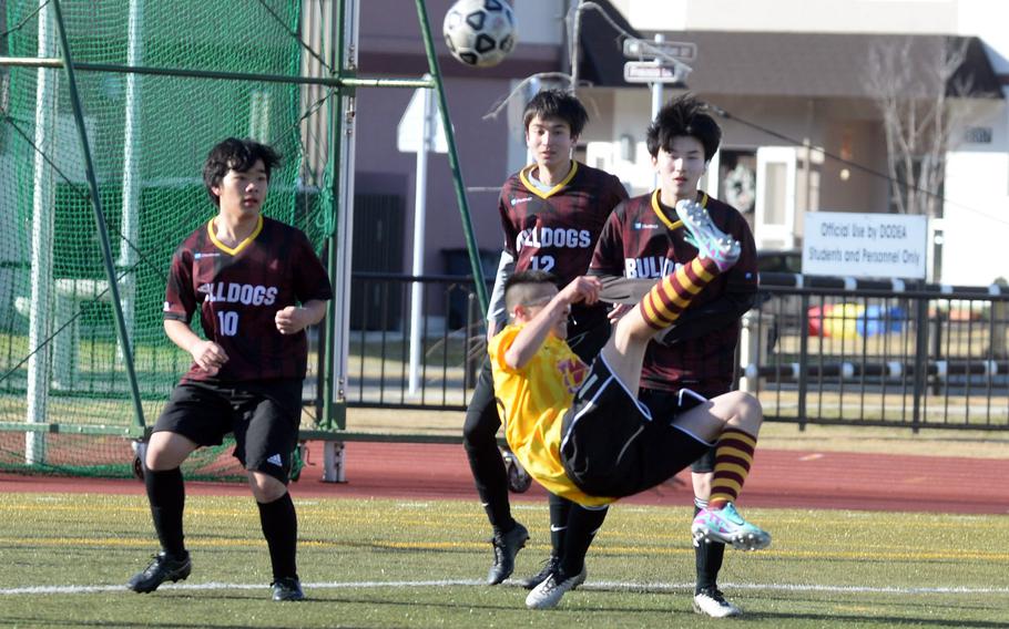 Perry's Anthony Salas attempts a bicycle kick in front of three Marist defenders.
