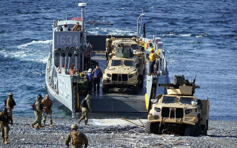 U.S. Marine Corps Joint Light Tactical Vehicles rumbled off a land craft from the USS Ashland at Numazu Beach Training Area, Japan, March 9, 2022.