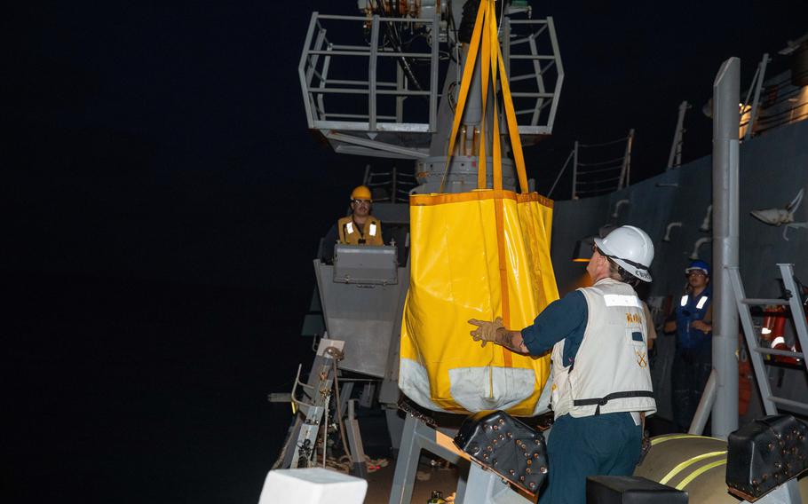 Sailors transfer contraband onto the boat.