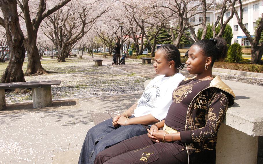 USS Kitty Hawk Seamen Shaniqua Washington, right, and Burnell Wright, left, waited to leave Yokosuka Naval Base, Japan, after they voluntarily signed statements saying they were homosexual, April 4, 2007. It would be another four years before “Don’t Ask, Don’t Tell,” the policy denying service members the right to serve openly in the U.S. military, would be repealed.            