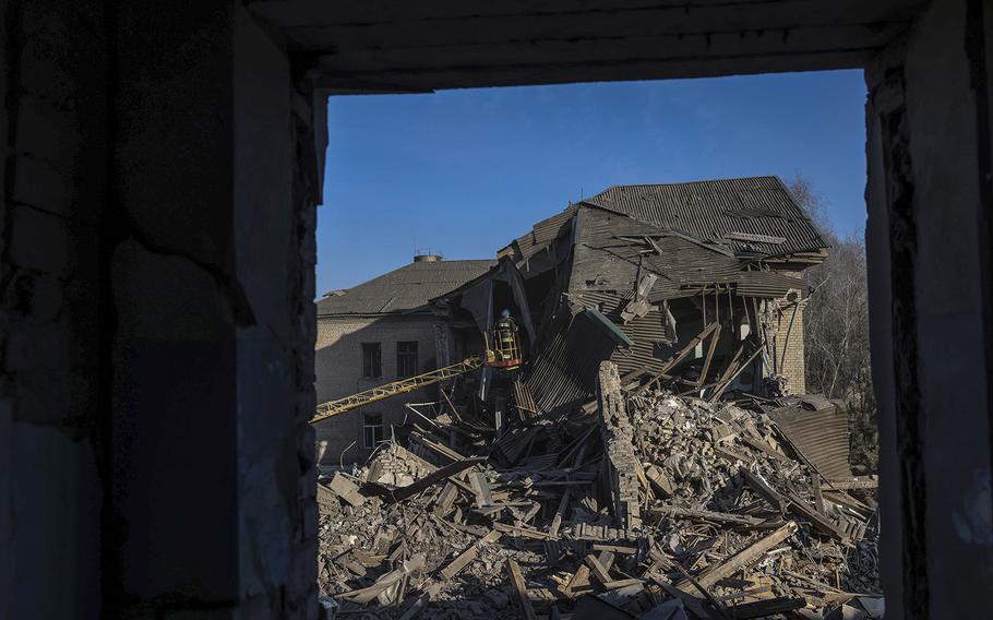Rescue workers search through the rubble of a hospital near Zaporizhzhia in Ukraine.