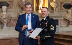 Army Master Sgt. Daniel Brooks receives the Christophorus Medal for lifesaving actions under difficult circumstances from Bavarian governor Markus Söder during a ceremony at the Munich Residence in Germany, on May 2, 2024.