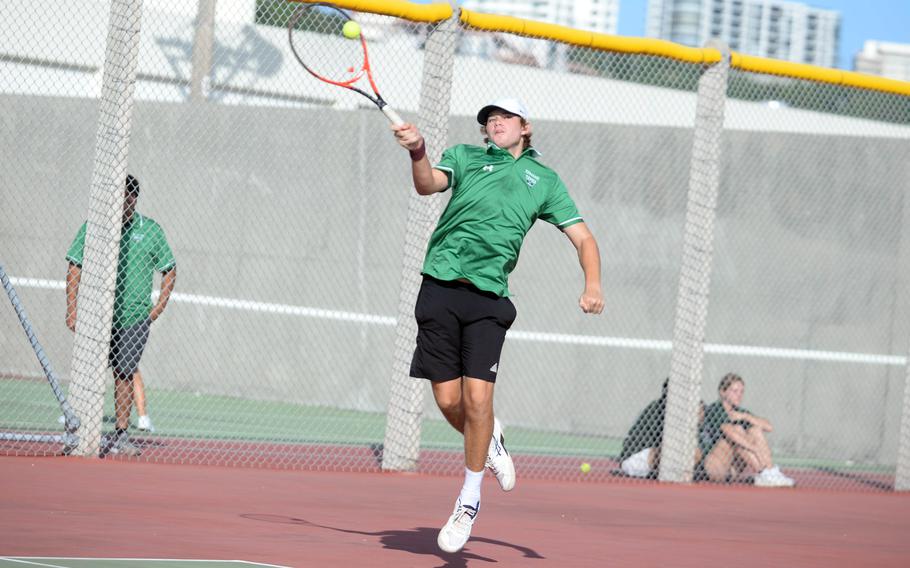 Kubasaki's Owen Ruksc skies to make a forehand return during Tuesday's Okinawa mixed-doubles tennis matches. Ruksc teamed with Lan Legros to beat Kadena's Maddux Fisk and Brooke Brewer 8-2 and the Dragons won as a team 5-1.