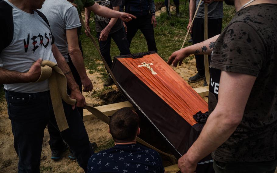 Andriy’s casket is lowered into the ground on Thursday.