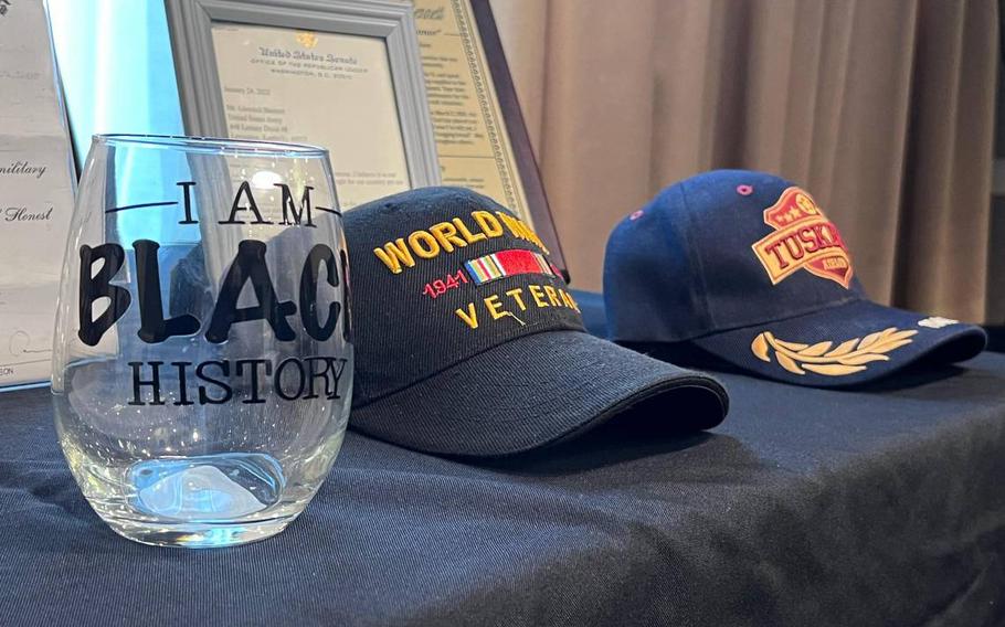 An “I am Black History” cup sits alongside WWII veterans and Tuskegee Airman military covers at WWII veteran Glendell Bennett’s 100th birthday celebration on Saturday, March 2, 2024, at the Embassy Suites by Hilton Lexington Green, Lexington, Ky.