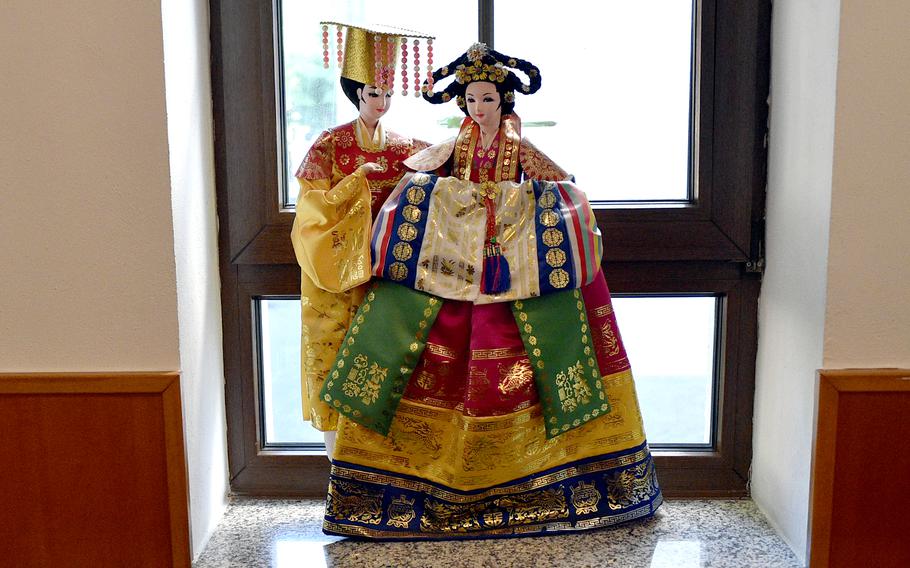 Dolls adorn a window of Restaurant Gautor Korea in Mainz, Germany. The decorative touches inside include figurines, artwork and lime green walls. 