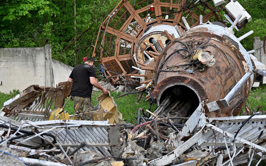 Ukrainian police investigators and workers examine debris at the Kharkiv Television Tower after officials reported a Russian strike on the tower, on the outskirts of Kharkiv on April 22, 2024. Photos and videos showed the top of the television tower breaking off and grey smoke billowing from the structure after Kharkiv Gov. Oleg Synegubov said in a social media post that Russia had hit a “television infrastructure facility.”