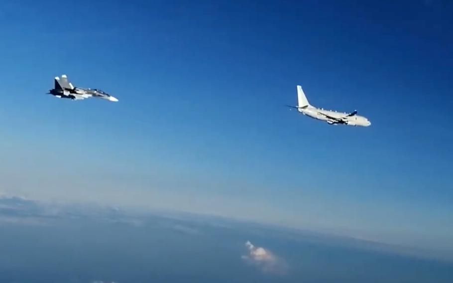 In this screenshot from a Russian Defense Ministry Facebook post, a Russian Su-30SM fighter follows a U.S. Navy P-8 Poseidon over the Black Sea, July 6, 2021, during NATO's Sea Breeze exercise.