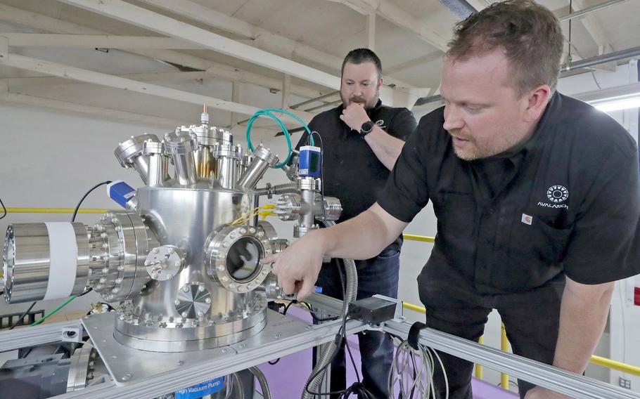 Avalanche Energy co-founders Robin Langtry, left, and Brian Riordan with their second prototype nuclear fusion reactor, on June 22, 2022. Avalanche Energy is a Seattle-based startup company that is in the process of developing a nuclear fusion reactor the size of a lunch box, called an “Orbitron.”