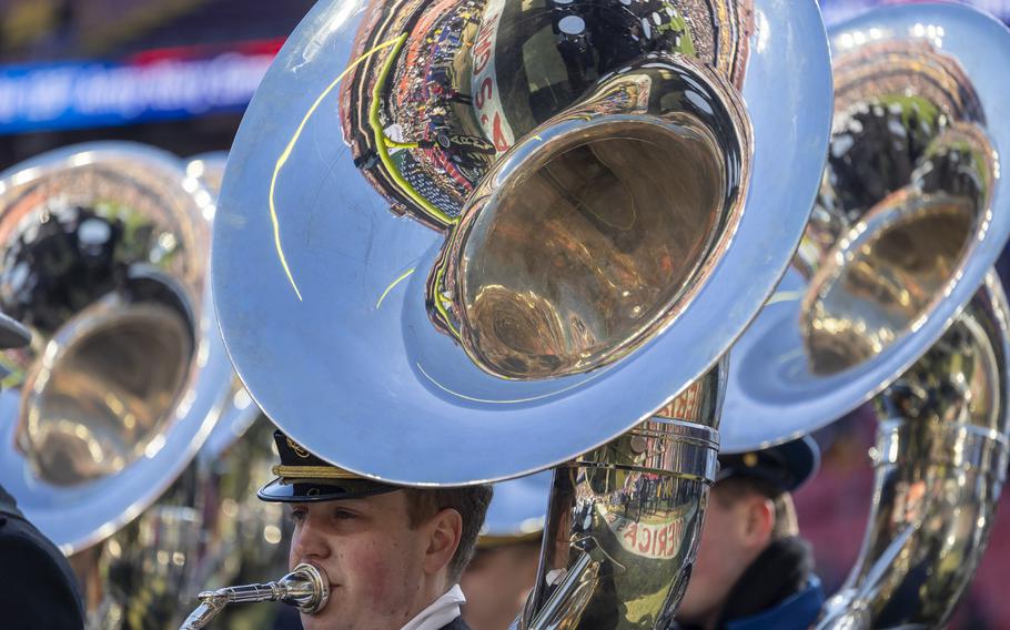 Navy band members play Sousaphones.