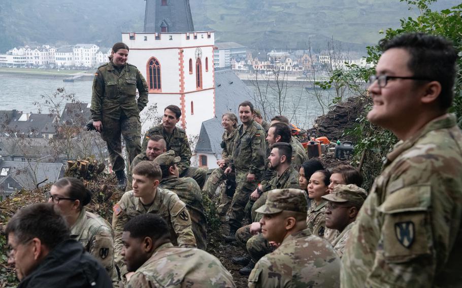 U.S. and German soldiers take a break from volunteer work in St. Goar, Germany, on Feb. 23, 2023. The soldiers helped preserve a centuries-old castle wall in the town along the Rhine River.