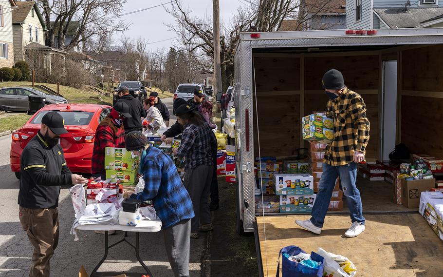 A local chapter of the Proud Boys hand out water, food and cleaning supplies to residents of East Palestine on Feb. 25, 2023, in East Palestine, Ohio. On Feb. 3, a Norfolk Southern Railways train carrying toxic chemicals derailed, causing an environmental disaster. Thousands of residents were ordered to evacuate after the area was placed under a state of emergency and temporary evacuation orders.
